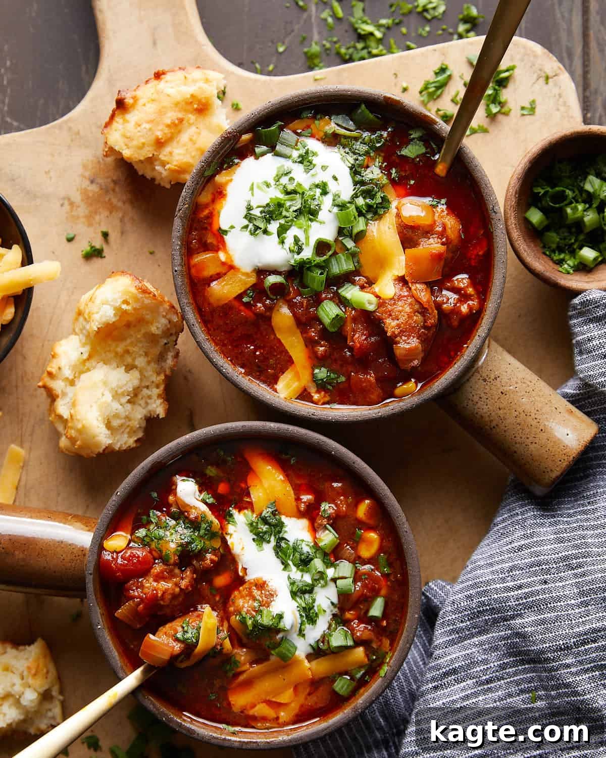 No-Fuss Slow Cooker Beanless Chili 2 Overhead image of slow cooker no bean chili with garnish, featuring shredded cheese and fresh cilantro.