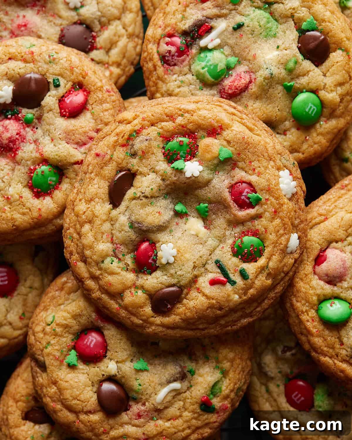 Holiday Chocolate Chip Magic 6 A close-up image of a perfectly baked Christmas chocolate chip cookie, highlighting its golden-brown edges, soft center, and visible festive M&Ms and sprinkles.