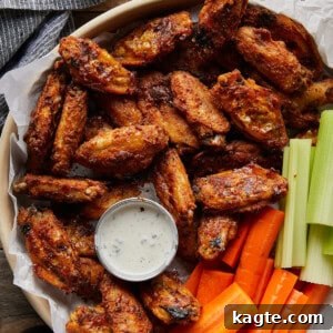 Appetizing image of crispy blackened chicken wings arranged artfully on a serving dish, ready to be enjoyed.
