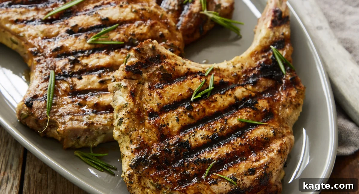 An overhead shot of grilled pork chops featuring a rosemary Dijon marinade, served attractively on a white dish.