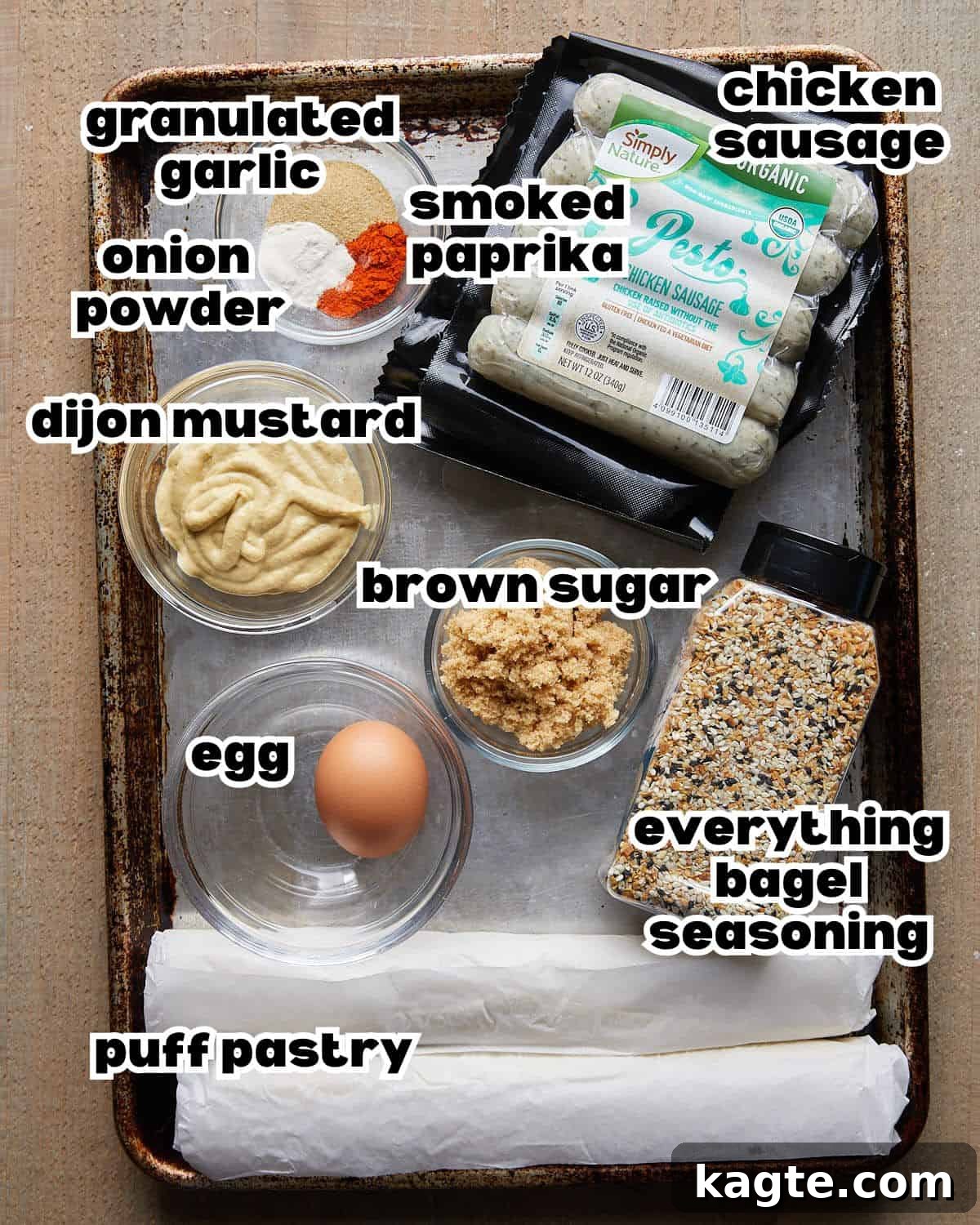 Flaky Golden Chicken Sausage Rolls 3 Overhead image of all fresh ingredients laid out on a white marble surface, ready to make chicken sausage rolls with puff pastry, including pastry sheets, chicken sausage links, mustard, brown sugar, and spices.