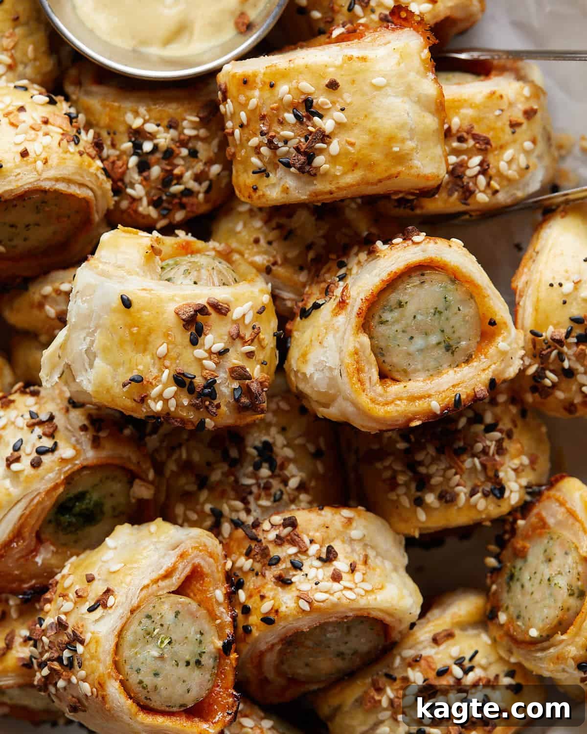 Flaky Golden Chicken Sausage Rolls 6 Up close image of golden, flaky chicken sausage rolls, garnished with everything bagel seasoning, perfectly baked and ready for serving.