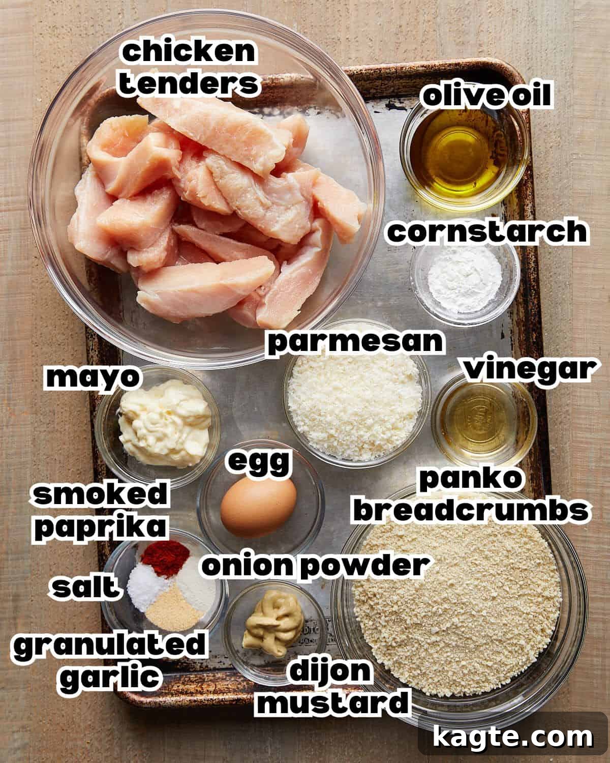 Overhead image displaying all the fresh ingredients required to make crispy chicken tenders, including chicken, panko, and spices.