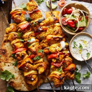 A vibrant plate of oven-baked chicken kabobs, garnished with fresh herbs and a lemon wedge, ready to be enjoyed.
