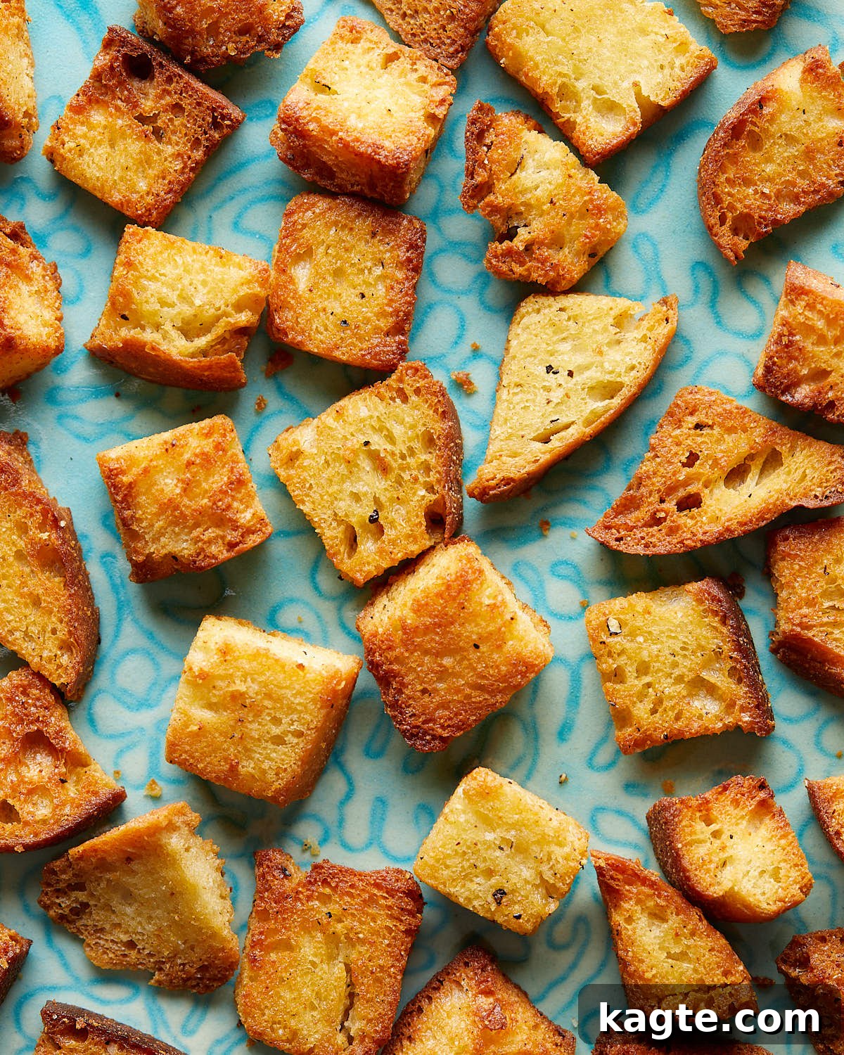 Perfectly Crispy Air Fryer Croutons 2 Overhead up close image of air fryer croutons on white dish.