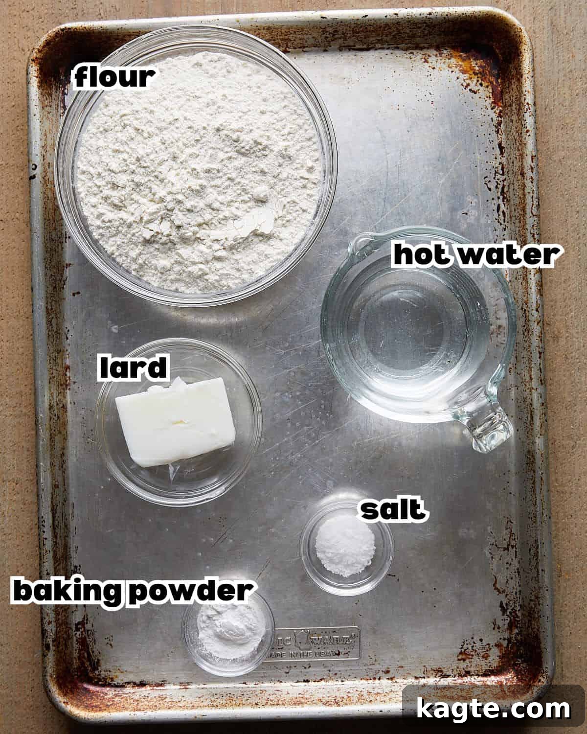Overhead image of ingredients needed to make homemade flour tortillas, laid out on a kitchen counter.
