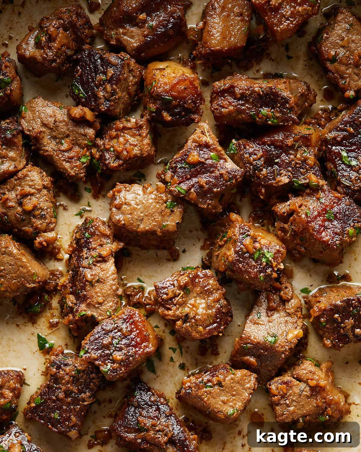 Succulent Garlic Butter Steak Bites 5 Up close overhead image of garlic butter steak bites with garnish.