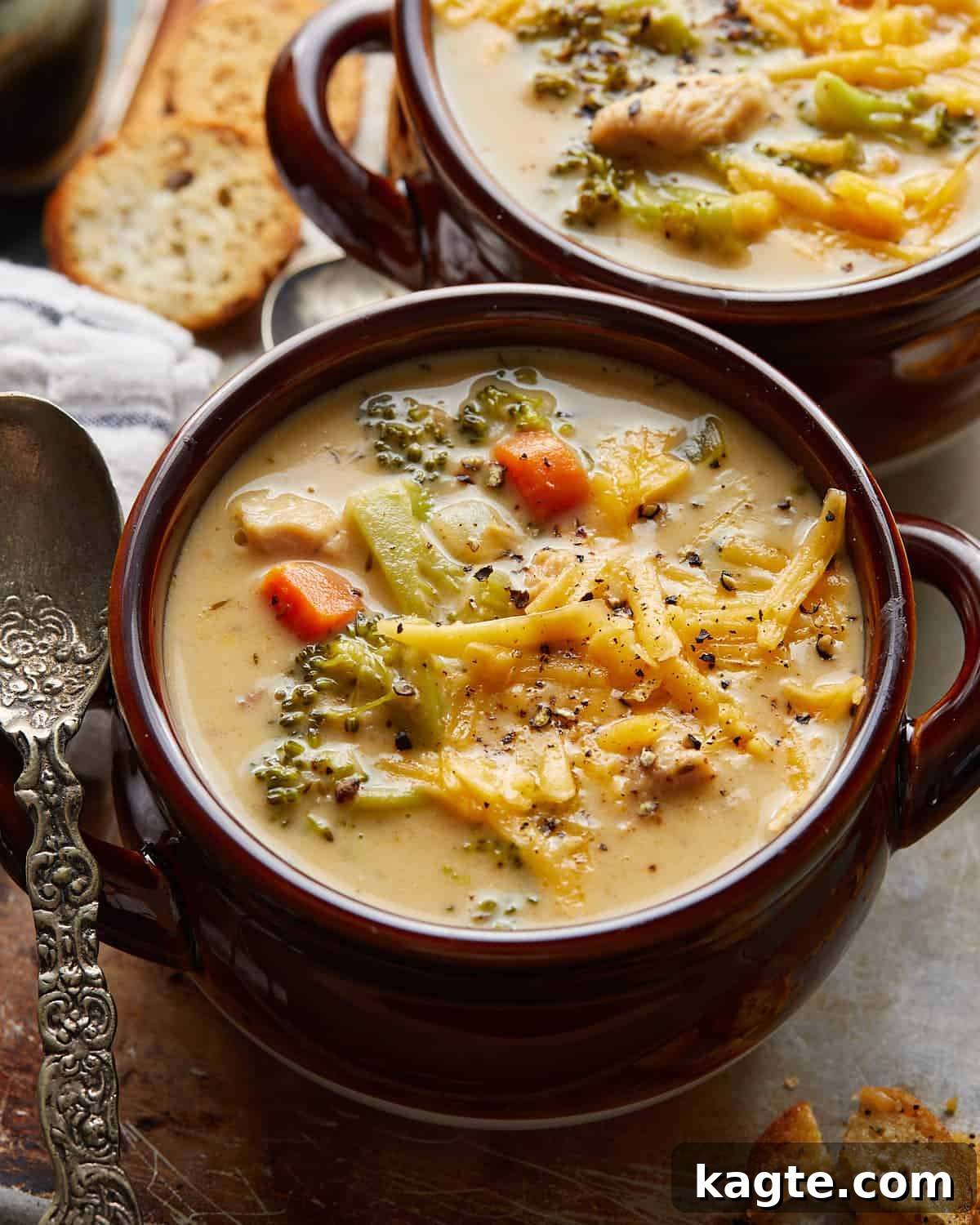 Protein Packed Chicken Broccoli Cheddar Soup 5 Up close and overhead image of chicken broccoli cheddar soup in brown bowl with garnish.