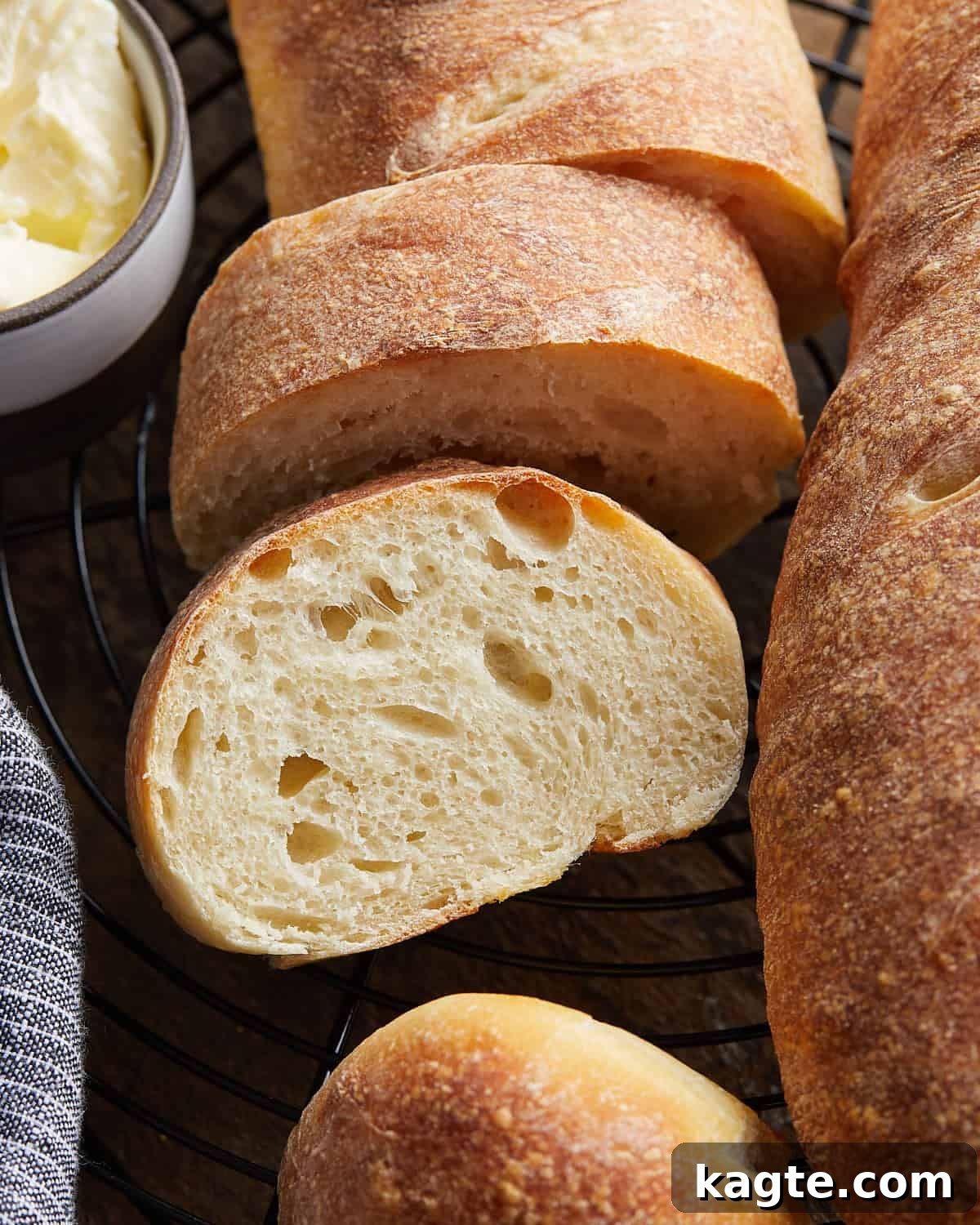 Perfectly Crusty Homemade French Bread 2 Up close overhead image of cut french bread on wire rack.