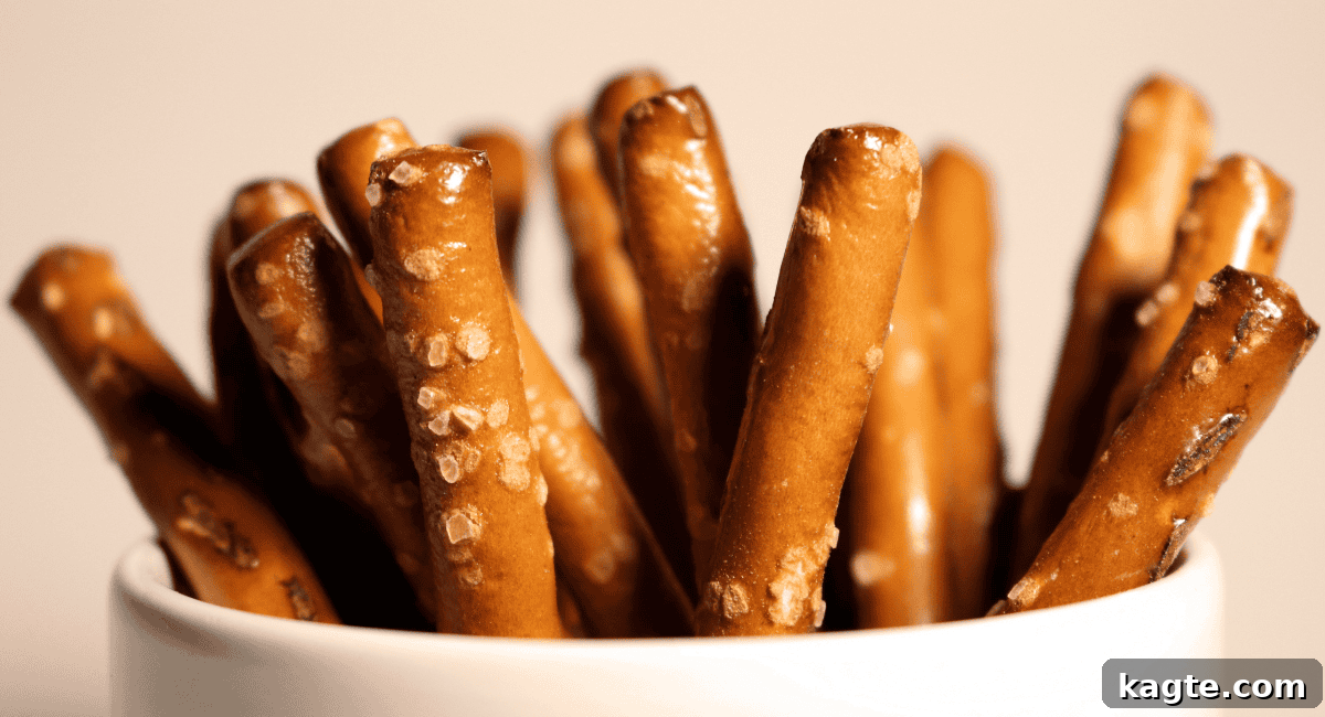 Up close image of pretzel sticks, perfectly salted and golden brown, ready for dipping.