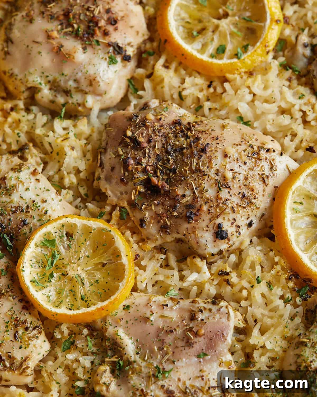 Zesty Lemon Chicken and Rice Bake 5 Up close image of baked lemon chicken and rice.