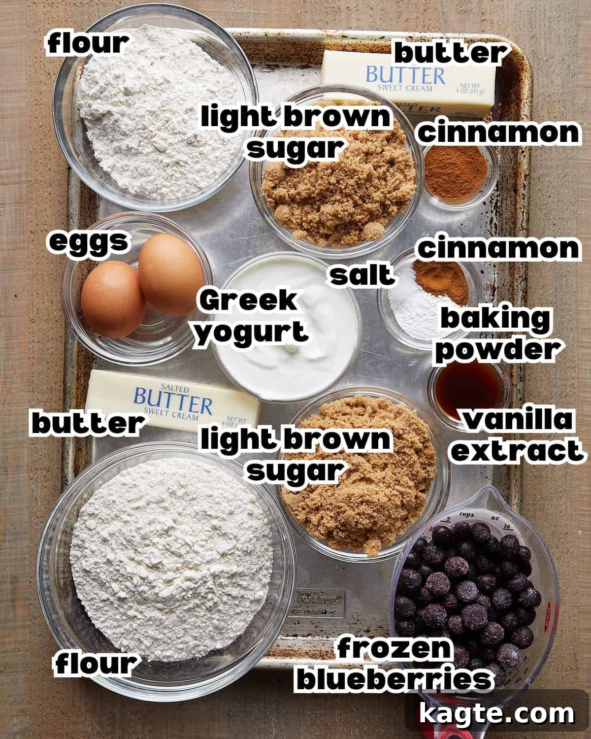 Tangy Greek Yogurt Blueberry Coffee Cake with Buttery Streusel 3 Overhead shot of all the ingredients laid out for making blueberry coffee cake, including butter, flour, sugar, eggs, yogurt, and blueberries.