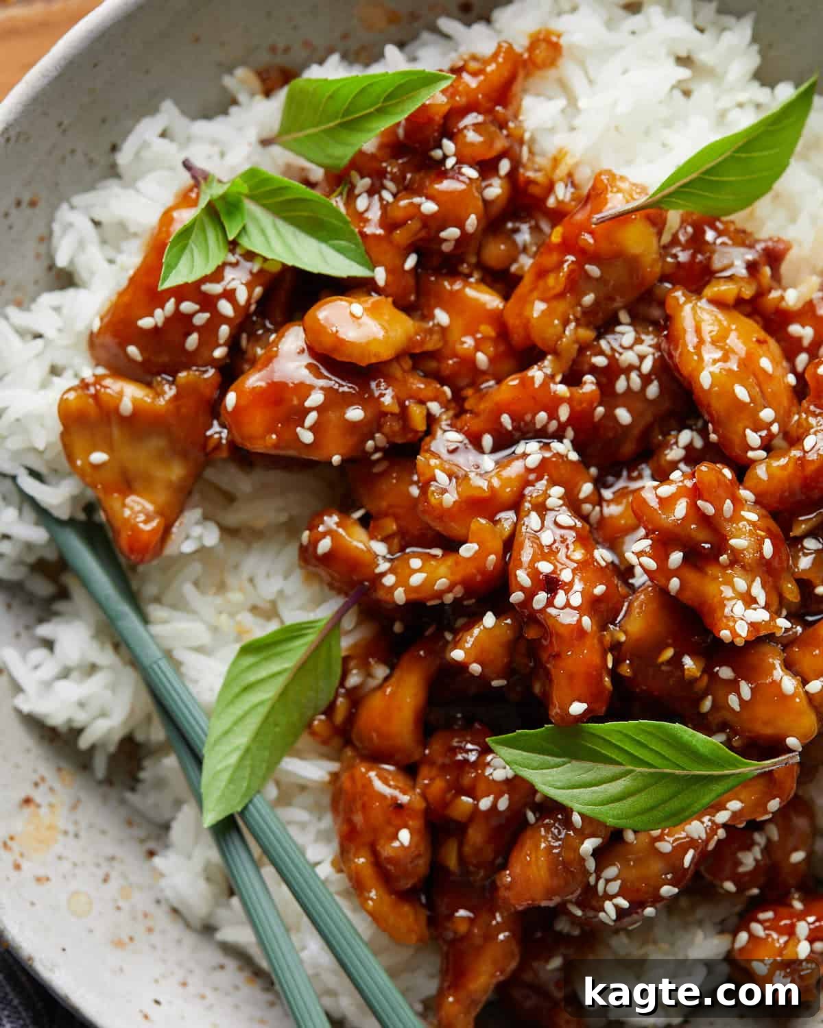 Up close overhead image of easy orange chicken recipe with garnish. 