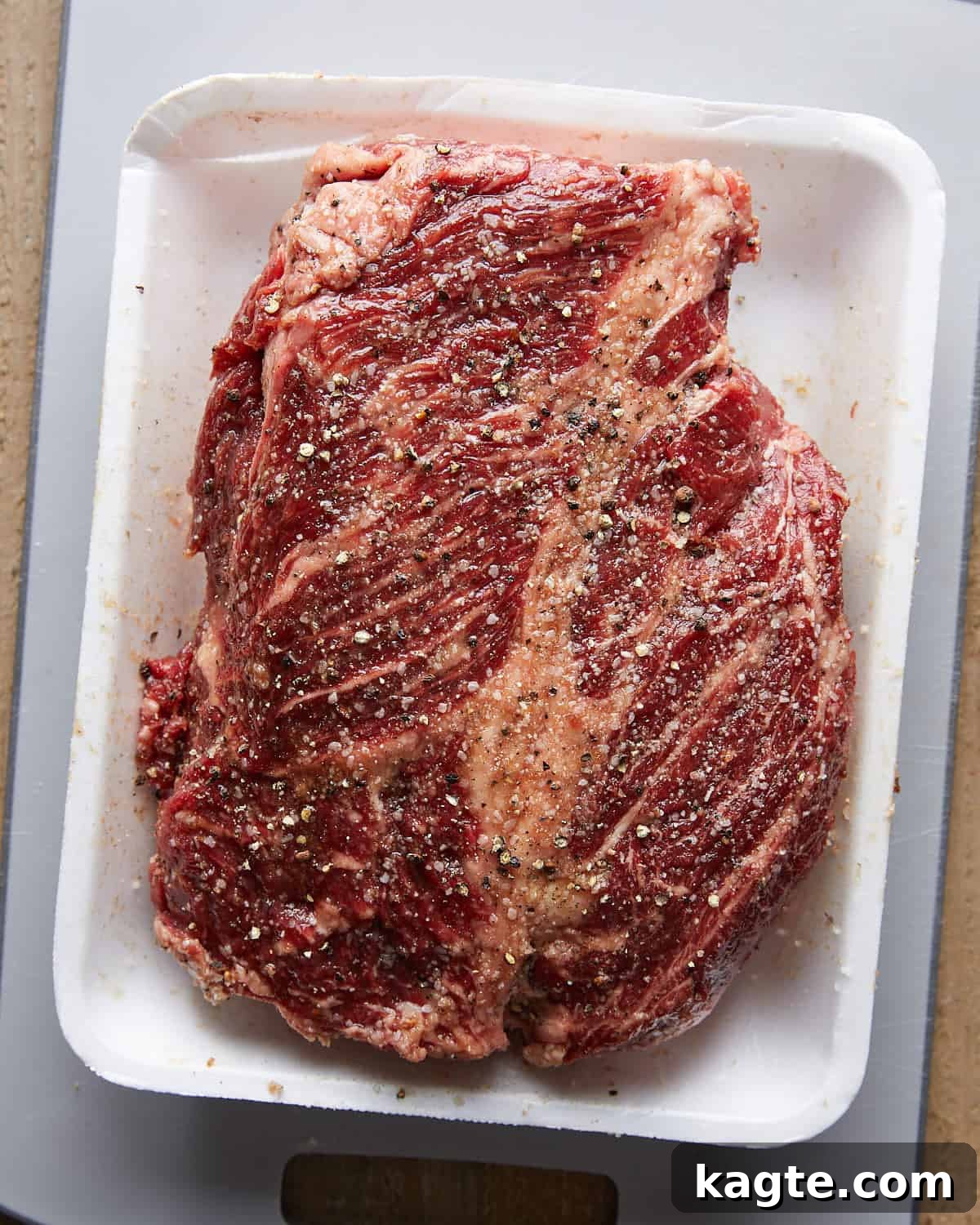 Overhead view of seasoned beef chuck roast prepared for Dutch Oven Pot Roast.