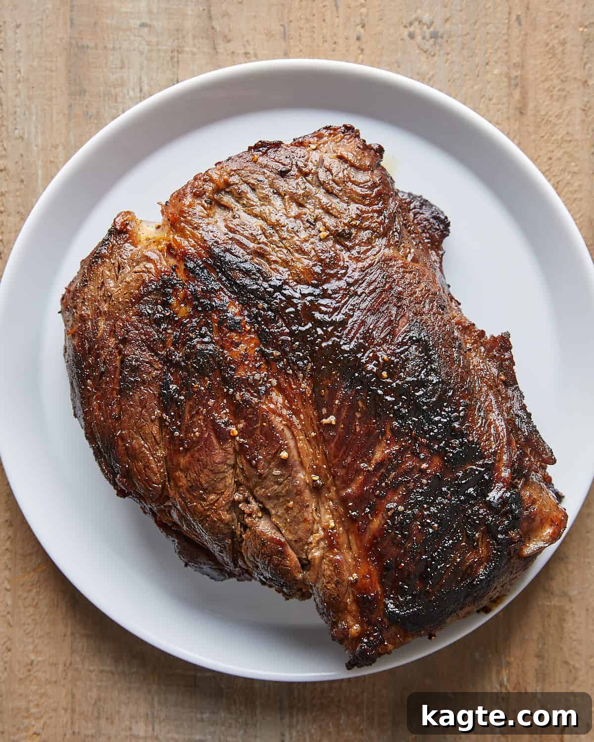 Overhead view of seared beef chuck roast prepared for Dutch Oven Pot Roast.