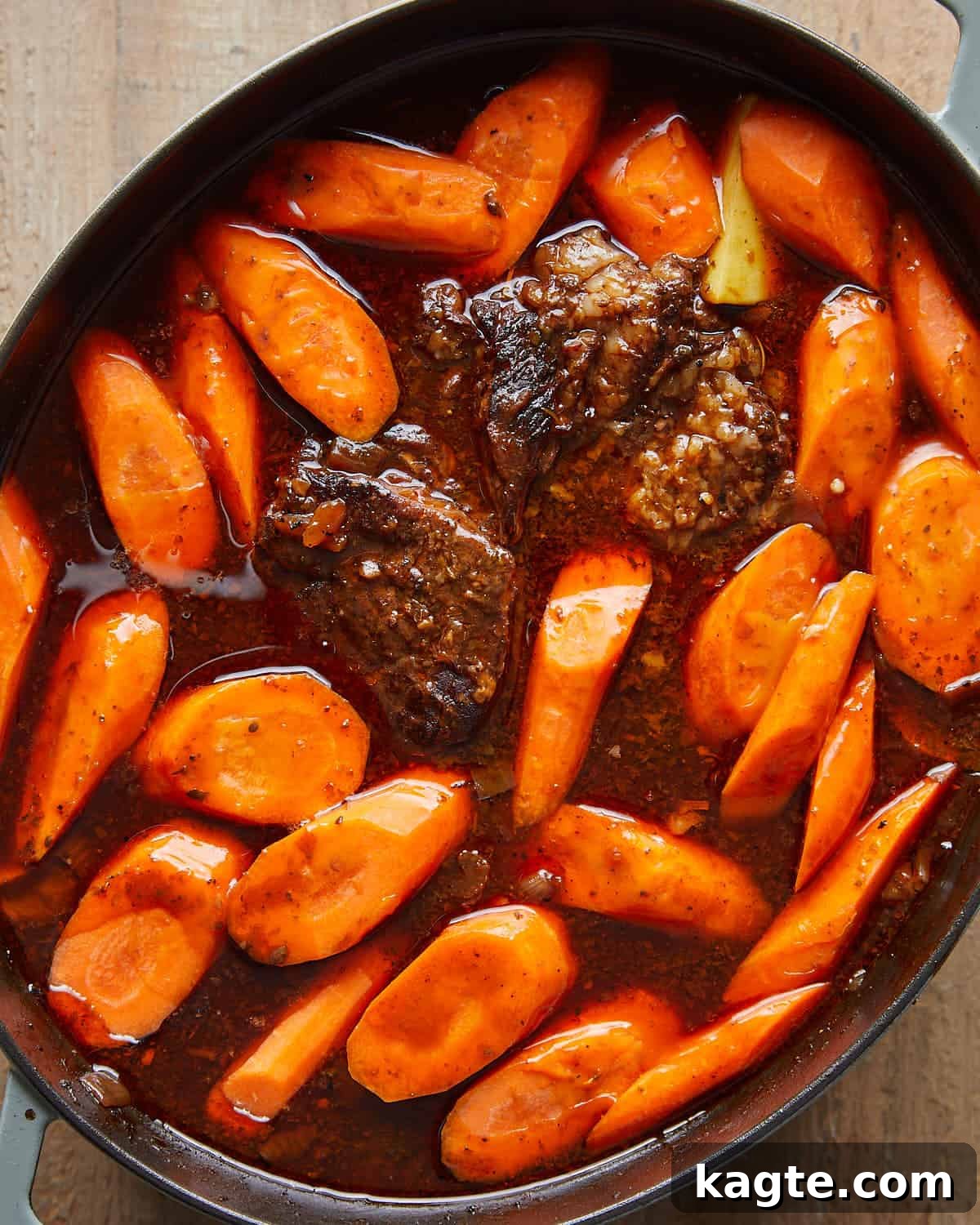 Overhead view of potatoes and carrots added to the pot for Dutch Oven Pot Roast.