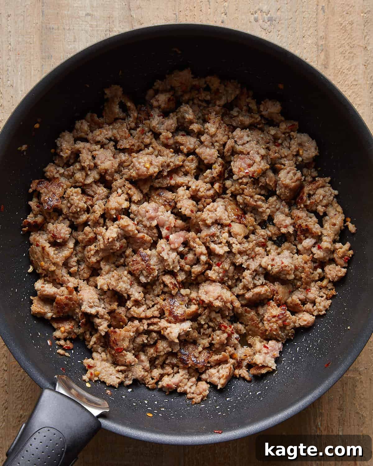 Cooked Italian sausage crumbled and browned in a skillet for baked stuffed shells.