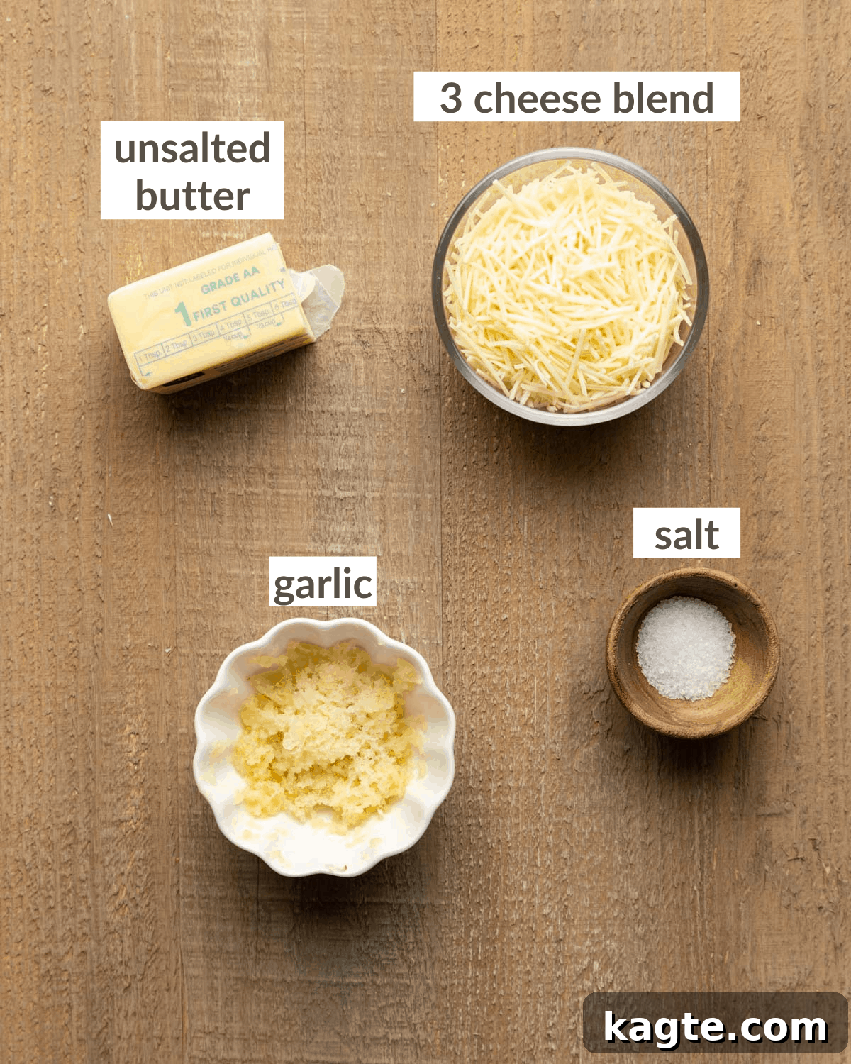 Cheesy Garlic Herb Swirl Rolls 4 Filling ingredients including softened butter, grated garlic cloves, salt, and a bowl of shredded Parmesan cheese blend.
