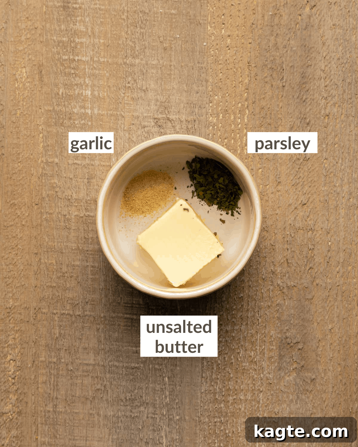 Cheesy Garlic Herb Swirl Rolls 5 Topping ingredients consisting of melted butter, granulated garlic, and dried parsley in small bowls.