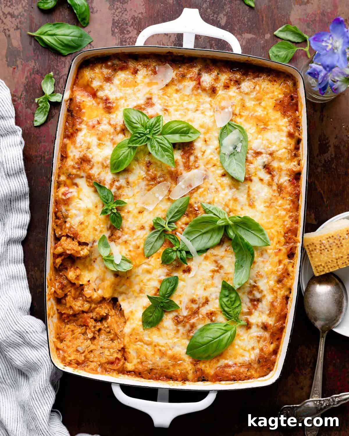 Overhead image of spaghetti squash casserole in white baking dish with garnish. 