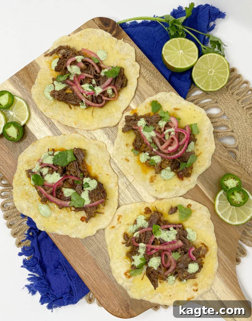 Fall-Apart Tender Instant Pot Barbacoa Tacos 2 I shredded my short rib barbacoa. I stuffed it in tacos. Lastly, I finished them with jalapeño lime crema, pickled onions, cilantro, and cheese.