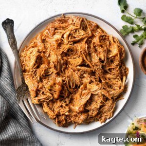 A vibrant close-up of shredded Instant Pot BBQ chicken in a serving bowl, ready to be enjoyed.