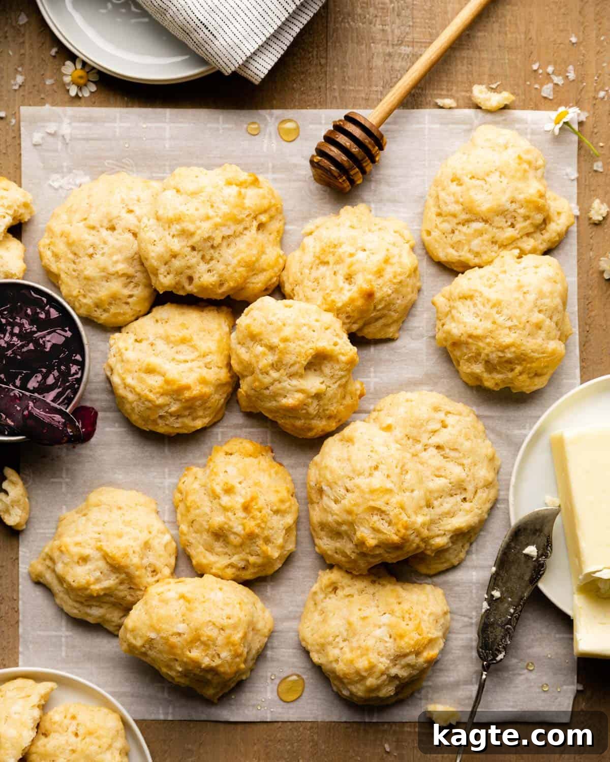 Effortless Dairy-Free Drop Biscuits 2 Golden-brown drop biscuits without milk on a piece of parchment paper, ready to be enjoyed.