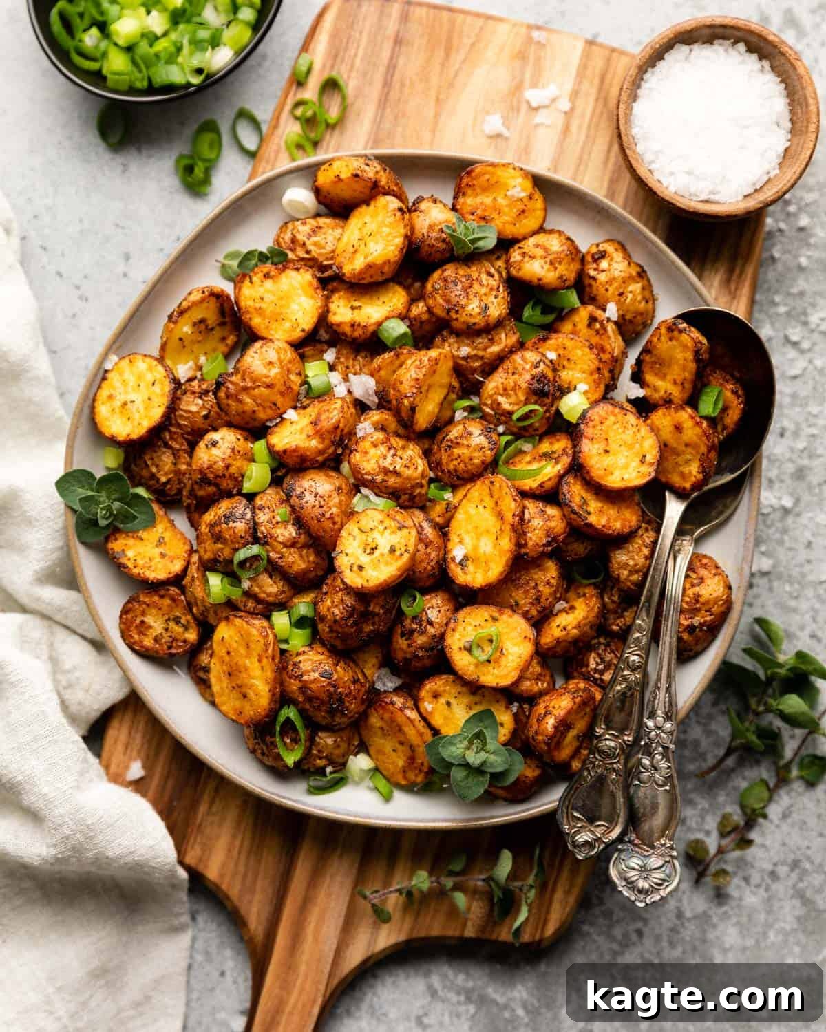 overhead of potatoes garnished with scallions and oregano 