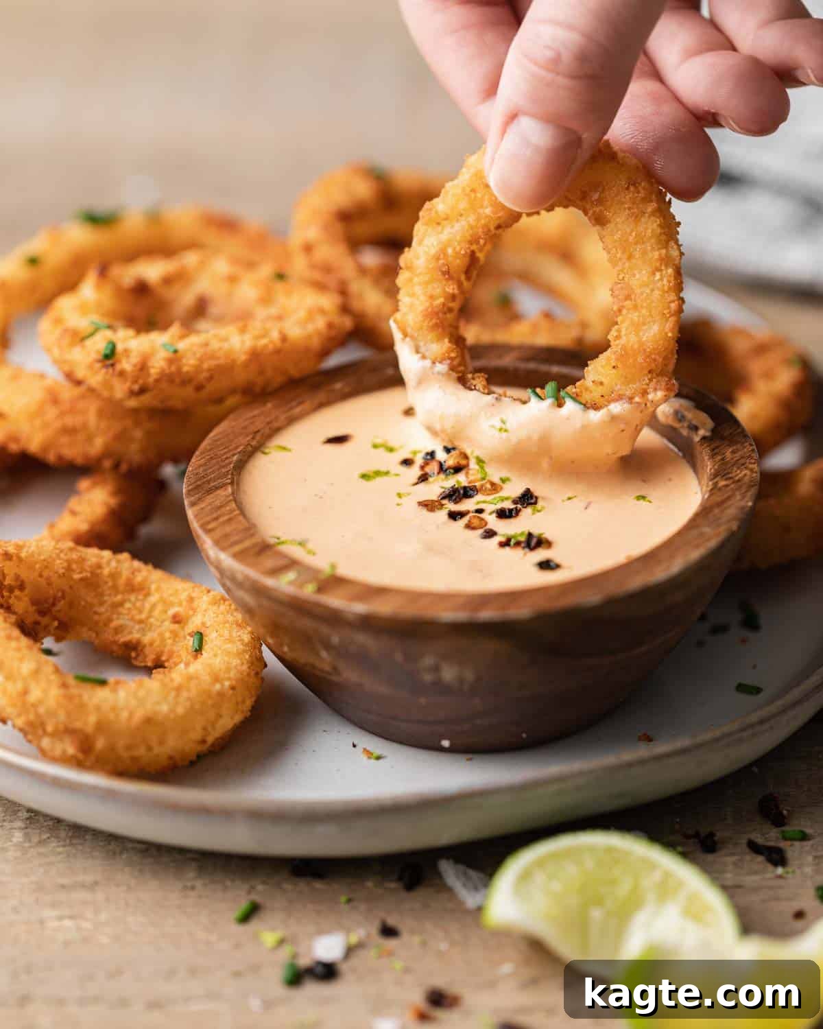 Smoky Chipotle Lime Crema 2 Onion ring being dipped in easy chipotle crema.