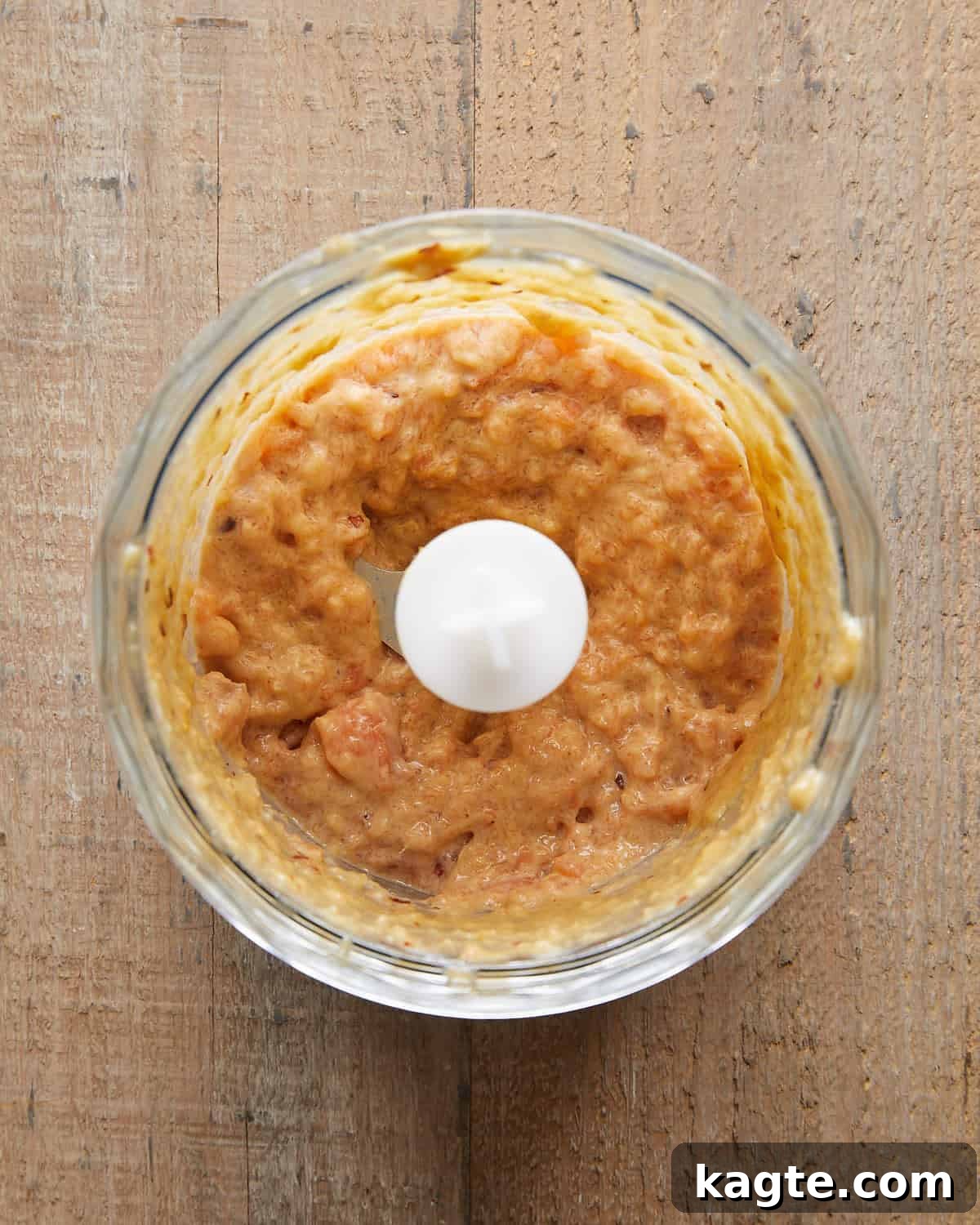 Flavor-Packed Salmon Burgers with Zesty Sriracha Aioli 5 Overhead image of salmon mixture blended into a slightly chunky paste with green onions, garlic, and seasoningsâready to form into Asian salmon burgers for a flavorful, tender texture.