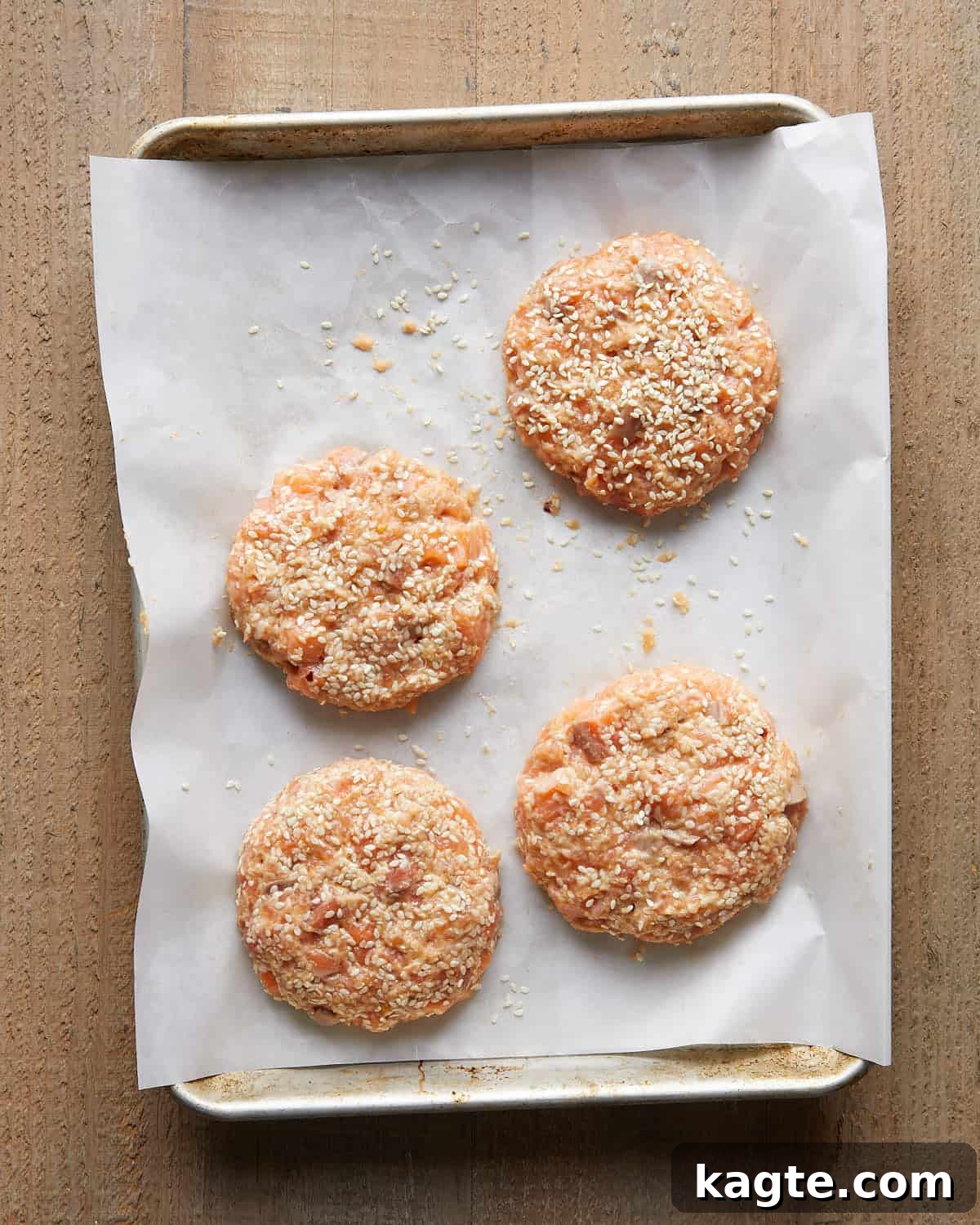Flavor-Packed Salmon Burgers with Zesty Sriracha Aioli 7 Overhead image of formed Asian salmon burger patties arranged on a tray, showing a lightly textured mixture of salmon, herbs, and seasonings ready to cook for flavorful Asian salmon burgers.