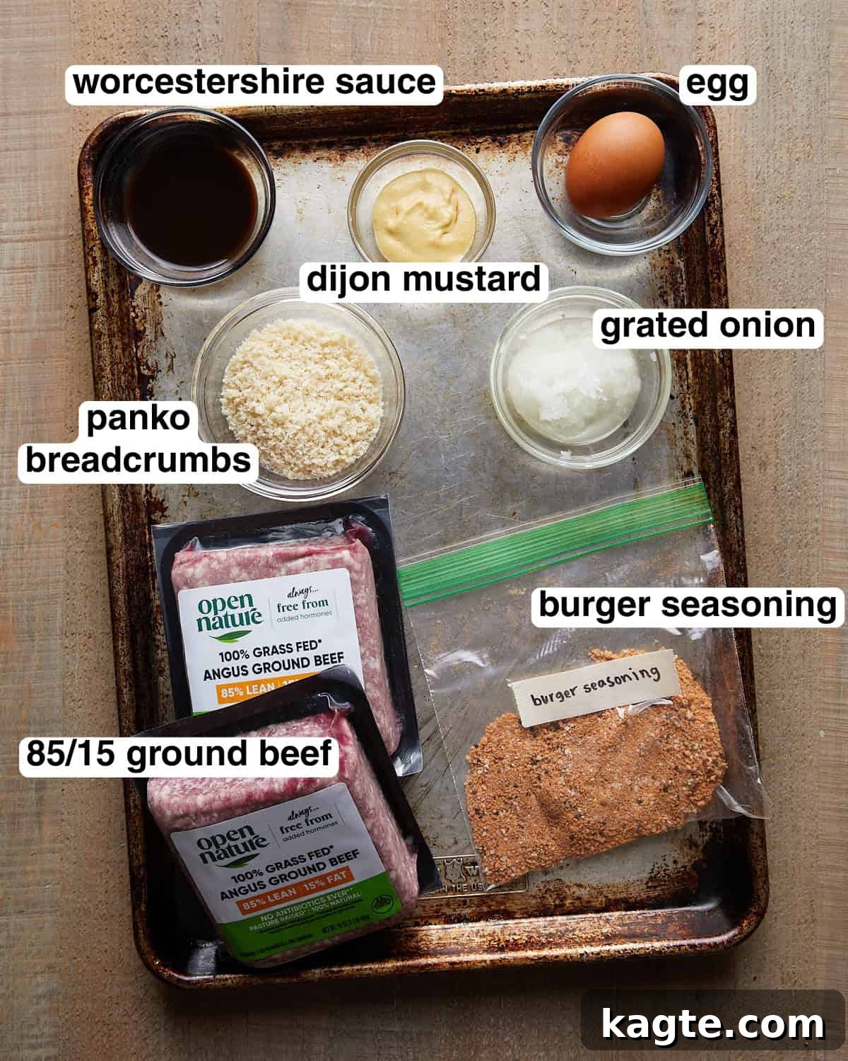 Juicy Grilled Hamburger Recipe for Perfect Backyard Burgers 3 Labeled ingredients for grilled burger patties, including ground beef, burger seasoning, panko breadcrumbs, Dijon mustard, grated onion, and sauce.