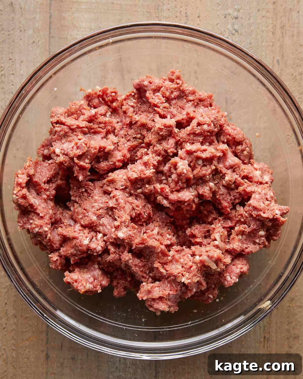 Juicy Grilled Hamburger Recipe for Perfect Backyard Burgers 4 Ground beef mixture in a glass bowl before shaping into burger patties.