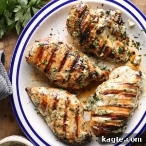 Grilled Chicken Marinated in Caesar Dressing 9 Overhead photo of grilled Caesar chicken breasts topped with herbs and served with Caesar sauce.