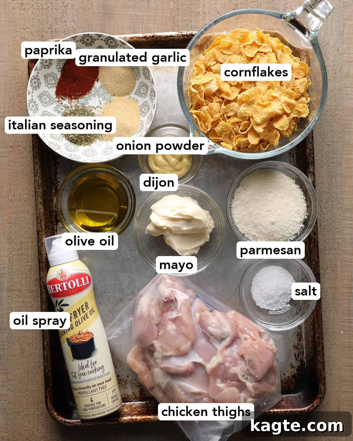 Crispy Baked Cornflake-Crusted Chicken Thighs 3 Ingredients for baked cornflake chicken thighs, including cornflakes, Parmesan, chicken thighs, mayo, Dijon mustard, olive oil, and seasonings