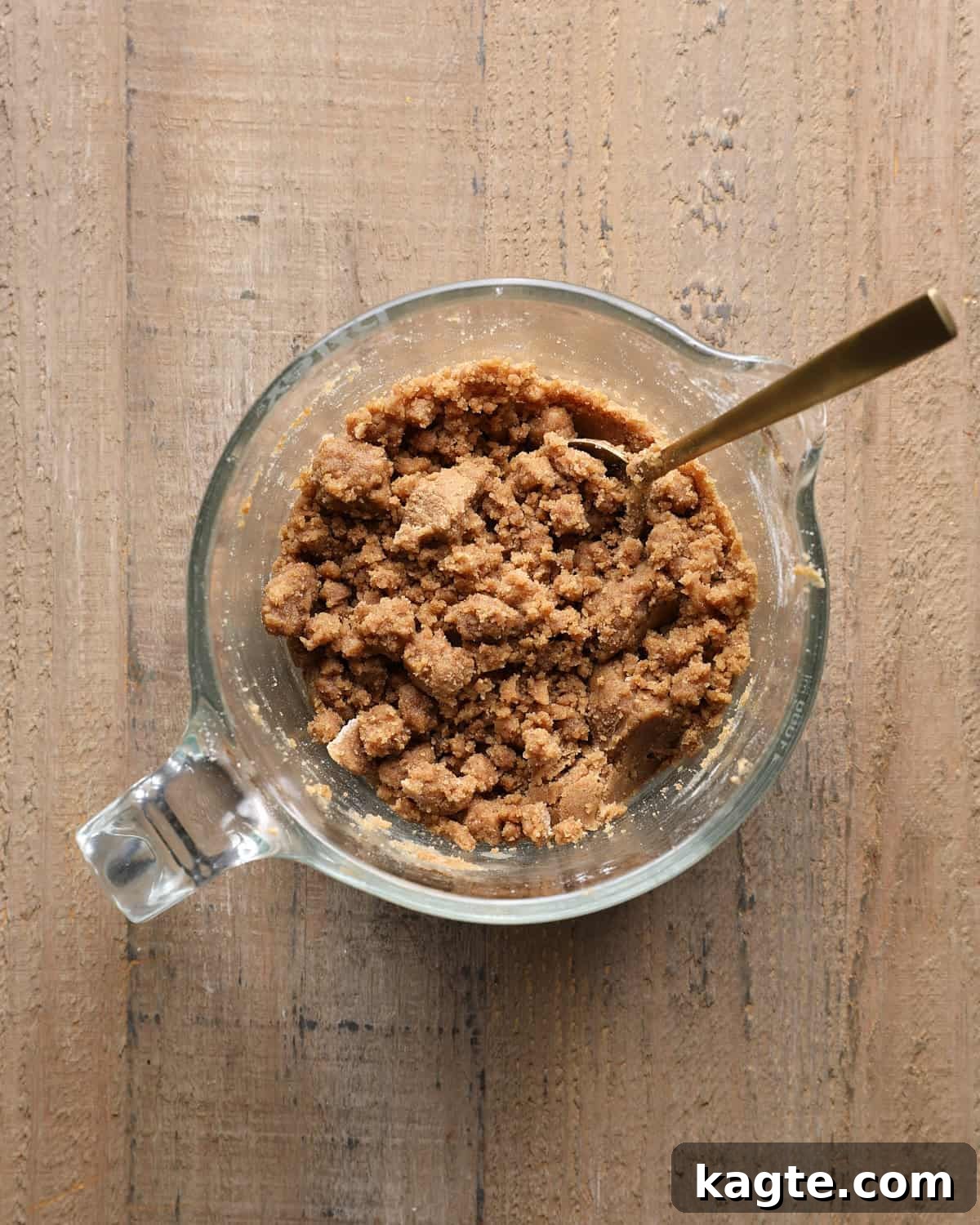 Apple Cider Muffins with Cinnamon Crumb Topping 5 Cinnamon crumb topping with large and small crumbs in a measuring cup.