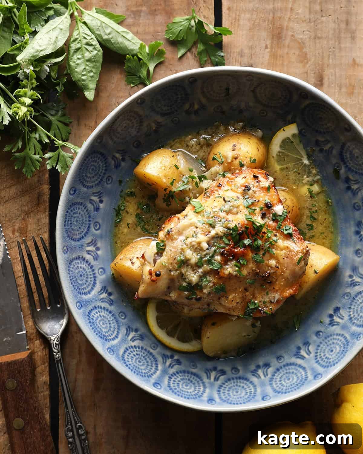 Slow Cooker Greek Lemon Chicken and Potatoes 2 Greek lemon slow cooker chicken and potatoes with parsley in a blue bowl.