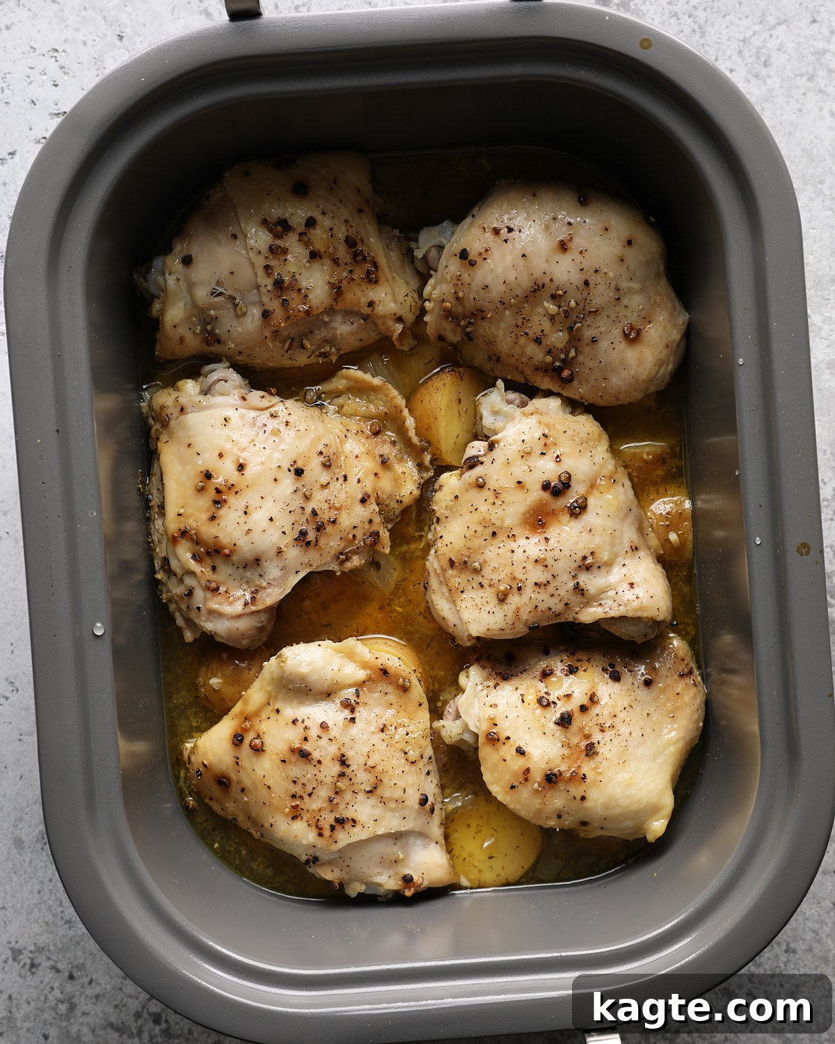 Slow Cooker Greek Lemon Chicken and Potatoes 7 Cooked chicken thighs and fork-tender potatoes in a slow cooker.